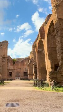 mid path ruines baths caracalla terme rome arched doors columns outgrowing plants them framing adds balance to reveals from long top down view of mid-path outlook 