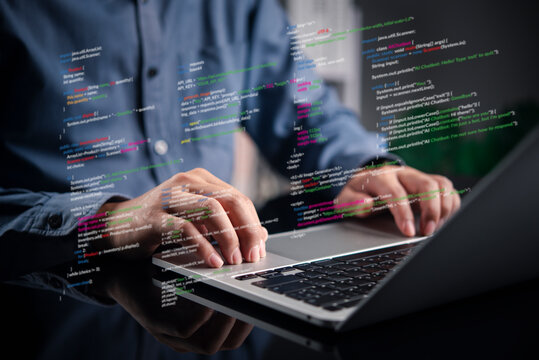 programmer typing on laptop with virtual code overlay. Software development, web design, and coding technology concept. IT engineer working on algorithm and programming script.
