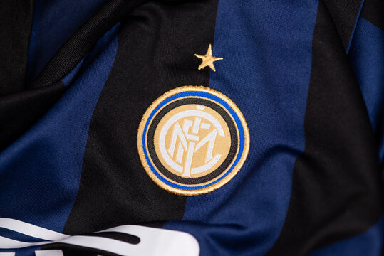 Close-up of Inter Milan football club crest embroidered on blue and black jersey fabric, symbol of Italian soccer tradition and sports identity.