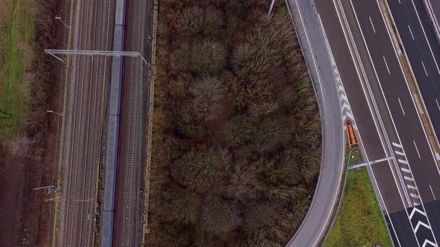 A Bird's-Eye View of Roads and Tracks: An eye-level shot captures the parallel lines of train tracks and highways, weaving through a tapestry of nature's green and earthy tones. 