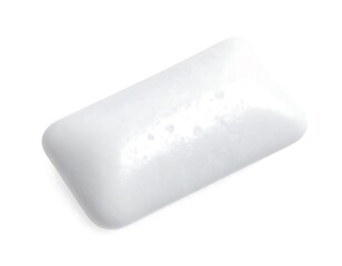 A close-up, top-down view of a single, rectangular stick of light-colored, slightly textured chewing gum against a white backdrop