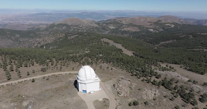Calar Alto Observatory Spain aerial with white telescope domes on mountain plateau showing astronomy research facility in highland landscape