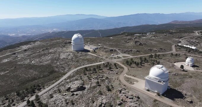 Calar Alto Observatory aerial showing multiple telescope domes and winding roads on mountain plateau Spain scientific astronomy facility