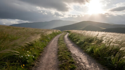 Wide road path mountain landscape sun sky grass hill nature tranquil view creates peaceful atmosphere. Dirt trail leads through rural countryside toward distant peak