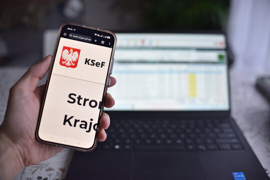 Wroclaw, Polska - 24 stycznia 2026: Od 1 lutego obowiazkowy system KSeF, rejestracja faktur online. Na zdjeciu: smartfon i strona KSEF, w tle laptop.