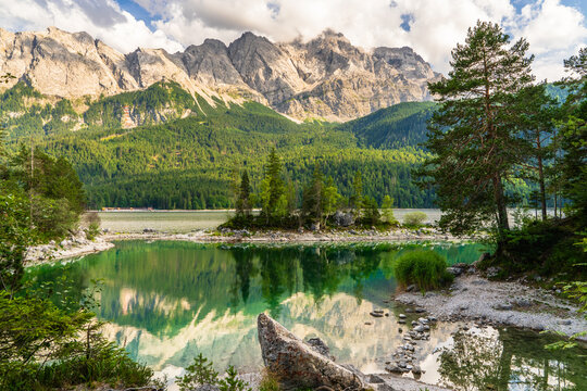 Beautiful Eibsee Lake with crystal clear turquoise water at foot of Zugspitze, Bavarian Alps, Germany. Stunning alpine landscape, travel, hiking, outdoor recreation.