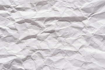 Fototapeta premium Textured white wrinkled paper close-up background for creative design and art projects.