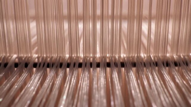 Textile threads moving on a loom machine
