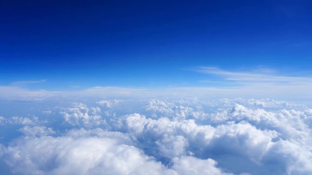 breathtaking view of a beautiful blue sky with fluffy white clouds, as seen from an airplane window, capturing the serene and vast atmosphere above the earth. sky view from airpl"