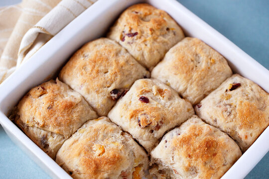 A baking dish filled with dried fruit sweet rolls