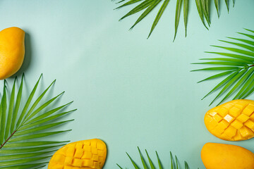 Summer colorfull concept with tropical fruits and leaves on green background, flat lay, top view,...