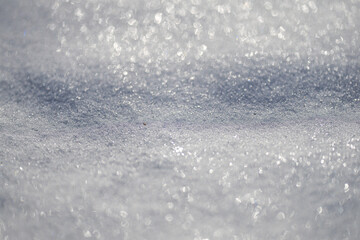 Obraz premium Frozen snow field in natural light. White snow backdrop with cold pattern. Minimal clean winter background. Frozen surface with snow and frost texture. Winter design with white snow.