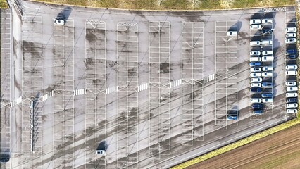 Aerial View of Large Parking Lot with Empty Spaces and Parked Cars