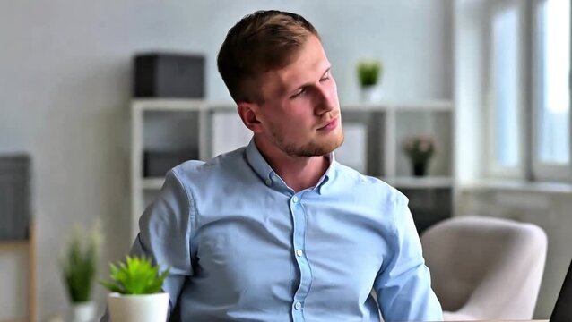 Corporate male model doing neck rolls and shoulder shrugs for wellness. Modern glass office interior with minimalist decor. Calm professional atmosphere and cool LED lighting reflections.