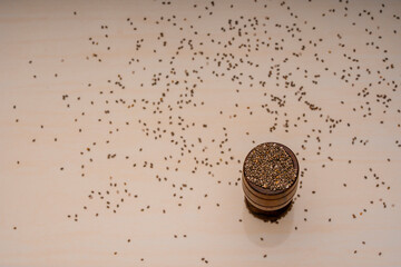 Chia seeds in a wooden bowl with a wooden spoon