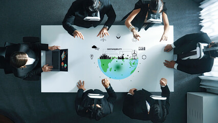 A diverse business team engages in a virtual reality meeting, discussing sustainability strategies...