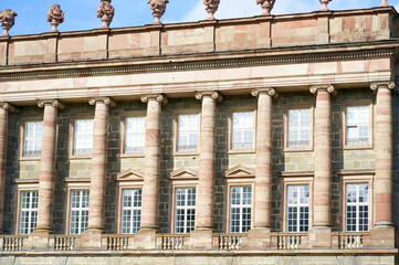 A close-up of a beautiful forged piece
a large building with large windows and beautiful columns