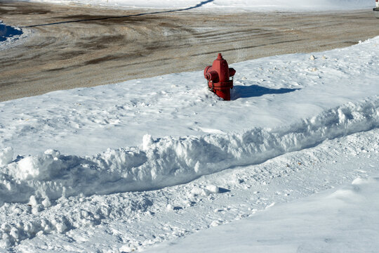 A red fire hydrant in the snow
