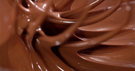 Viscous Cocoa Swirling Dynamically, Lustrous Ribbons Of Melted Chocolate Stirred By Chef In Kitchen