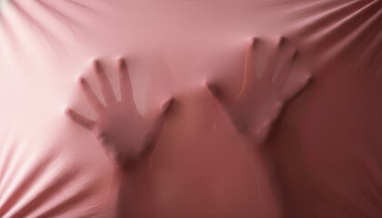 Silhouettes of Hands Trapped Behind Pink Fabric