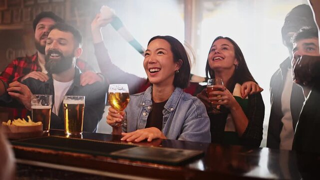 Excited friends celebrating a goal together in a pub