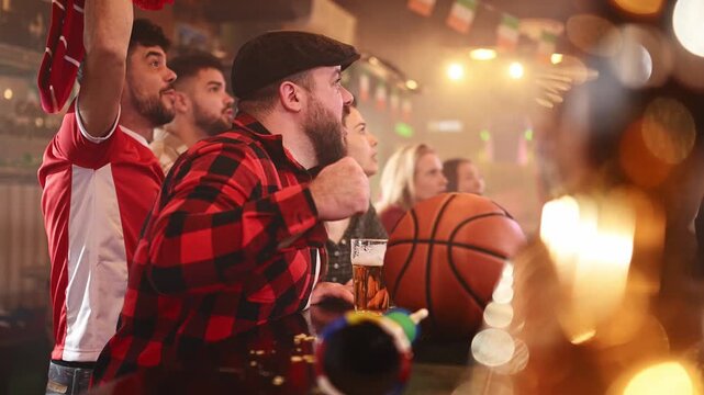 Excited basketball fans cheering and celebrating victory in a sports bar