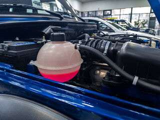 Tank of liquid antifreeze of the cooling system of the car radiator system. Tank with antifreeze close-up