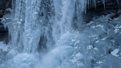 Frozen waterfall with icicles and snow