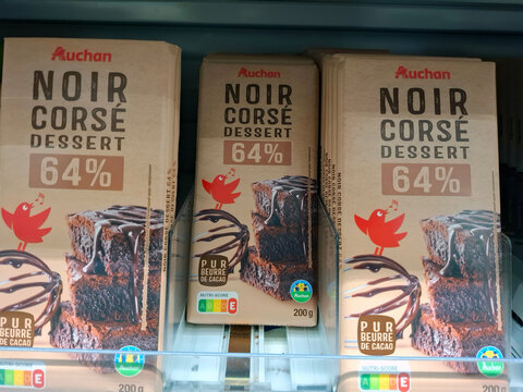 AVIGNON, FRANCE - October 31, 2025.Rows of Auchan dark chocolate dessert bars on display at a gas station in Provence, France