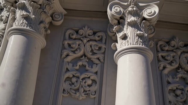 The image features ornate architectural details on a building. The decorative columns and intricate carvings emphasize the style and craftsmanship of the structure.