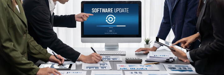 Panorama shot analyst team utilizing BI Fintech to analyze financial report with laptop. Businesspeople analyzing BI data dashboard displayed on laptop screen for business insight. Prodigy