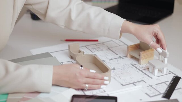 Interior design Female architect examining scale model designs with construction plans, sunlight.