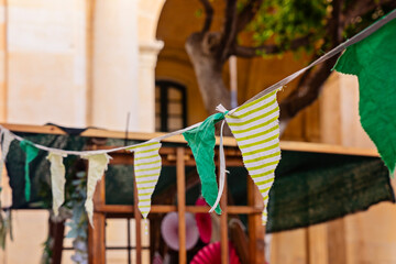 Striped bunting flags across courtyard festival canopy