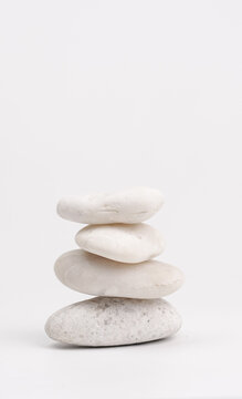 pile of white stones isolated on white background. Stones pyramid. Life balance and harmony concept.vertical.