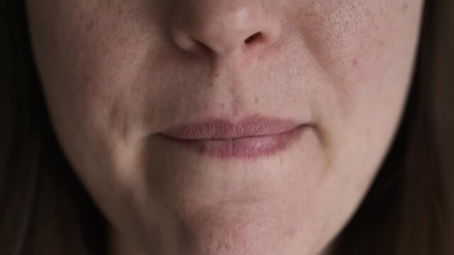 nervous, biting lips. A girl or a woman experiences a feeling of anxiety, neurosis, uncontrollable actions, mental illness