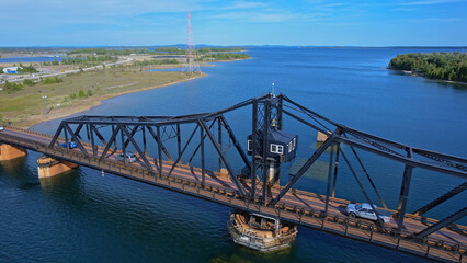 Aerial view of single lane traffic on Little Current Swing Bridge, Manitoulin Island. The bridge...