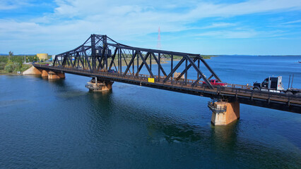 Aerial view of single lane traffic on Little Current Swing Bridge, Manitoulin Island. The bridge crosses North Channel on Highway 6. The historic bridge will be replaced with new two lane bridge.