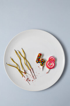 Candles in the shape of the number 48 on plate. Forty eight year birthday celebration concept. Selective focus, copy space