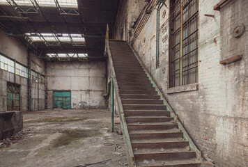 Steel staircase inside an abandoned industrial factory hall.