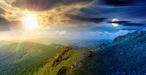 summer solstice mountain landscape. day and night time change concept. rocks on edge of hill with sun and moon at twilight. view in to valley. grassy slope under cloudy sky. distant ridge on horizon