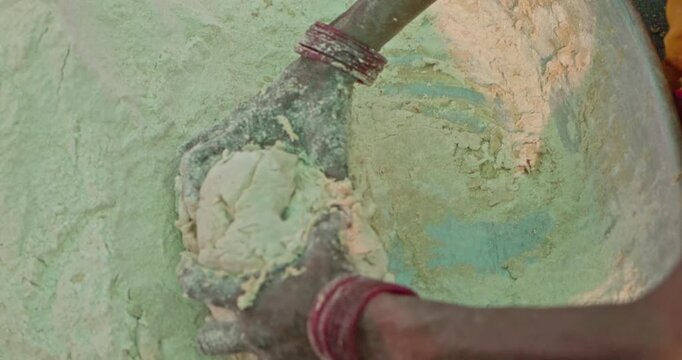 Indian Village Women And Men Preparing Mahaprasad Roti for a Spiritual Mass Gathering