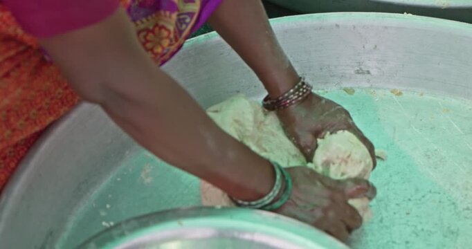 Indian Village Women And Men Preparing Mahaprasad Roti for a Spiritual Mass Gathering