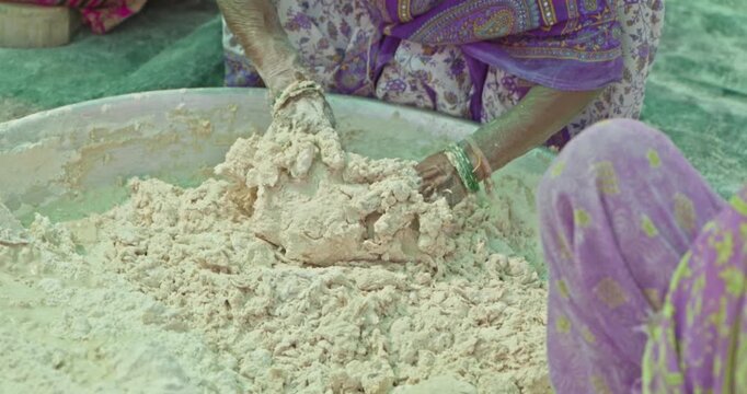 Indian Village Women And Men Preparing Mahaprasad Roti for a Spiritual Mass Gathering
