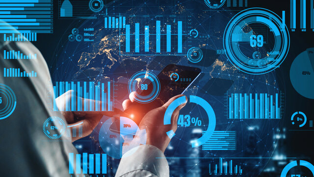 A businessman engages with a smartphone in a modern office, surrounded by digital graphs and charts that represent financial data and analytics in a futuristic setting. Xenic - Powered by Adobe