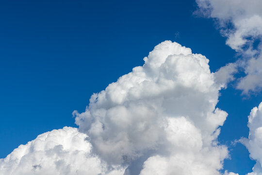 Vibrant blue sky with large puffy white clouds