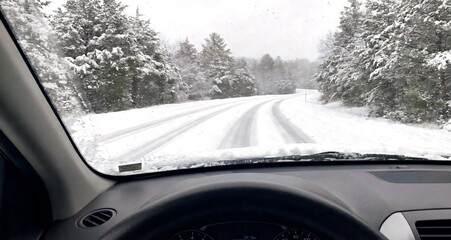 Driver Point of View Looking Through Windshield at Snowy Road