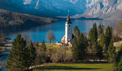 Close Up Aerial of St John the Baptist Church at Lake Bohinj: 70mm Cinematic View with Triglav Mountains, Slovenia