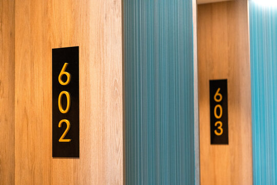 Modern hotel corridor with room numbers 602 and 603 doors