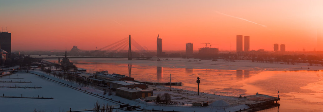 Wintry sunset over the Daugava River in Riga with Vansu Bridge