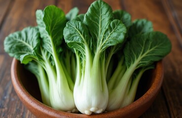 Fresh bok choy bunches sit in a rustic bowl. Crisp green leaves and pale stems show plant freshness. This healthy Asian vegetable is ready for cooking or salads.